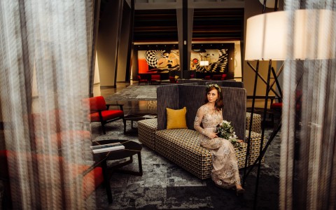 Photo credit to Olga Polo, a bride posing in a room looking out into the distance