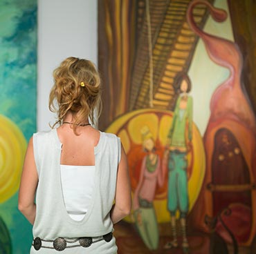 Woman standing in front of artwork