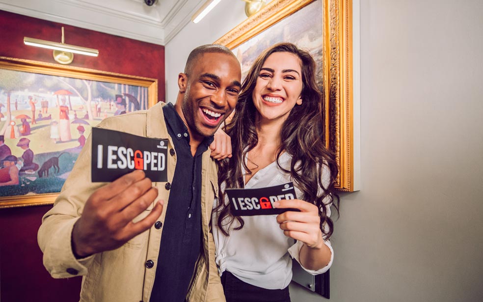 two people smiling after completing the escape room