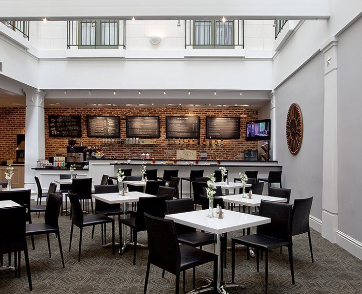 white tables and chairs in cafe and bar with red brick