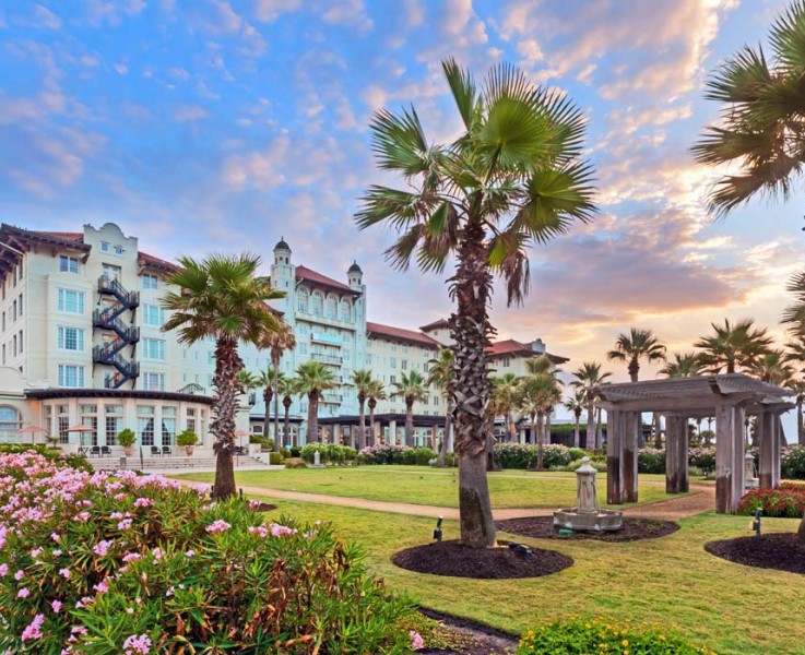 the exterior of hotel galvez during the sunrise