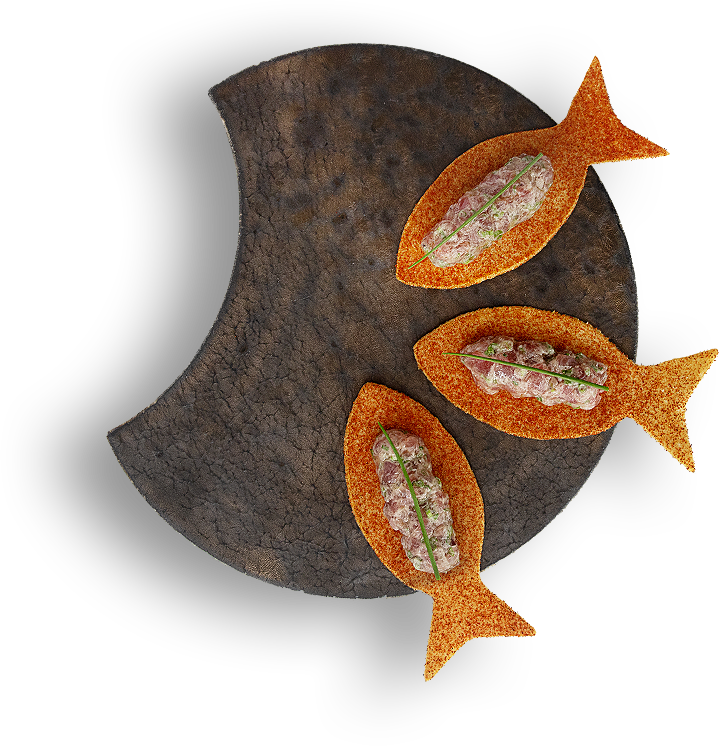 three orange fishes on a brown plate 