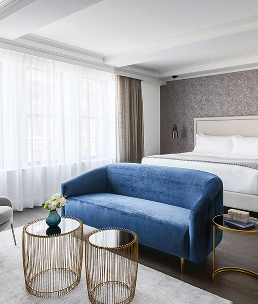 bedroom with a bed and a blue couch