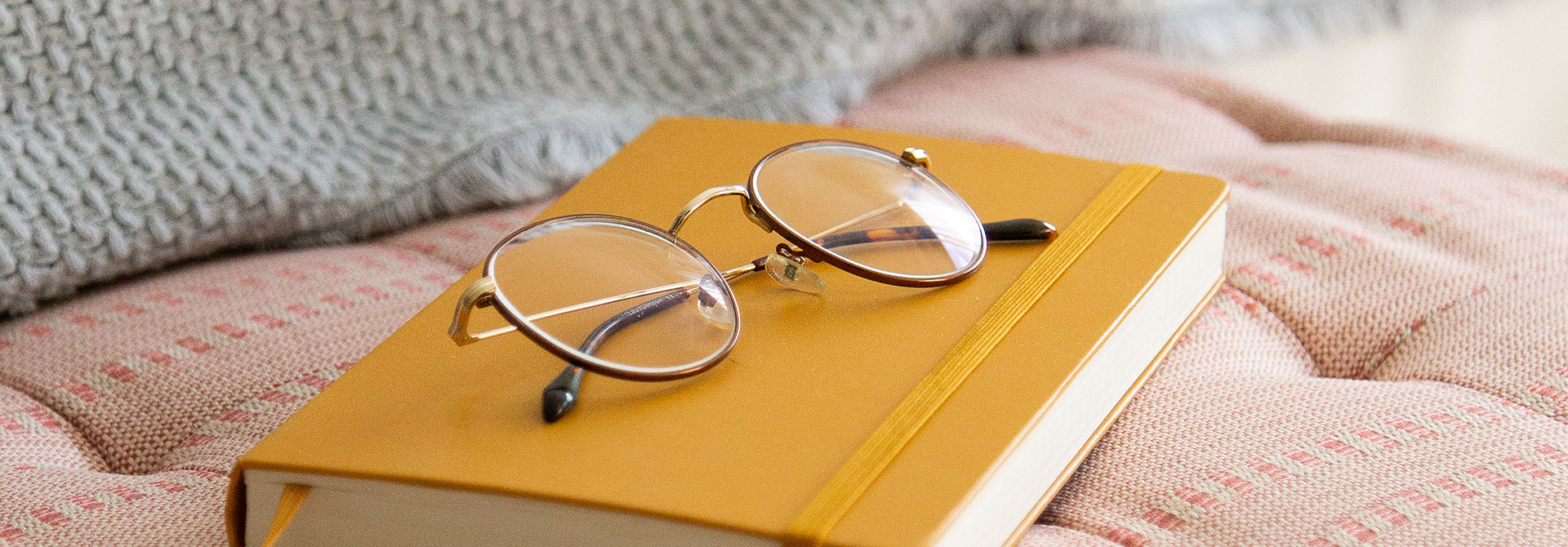 close up image of glasses on top of a book