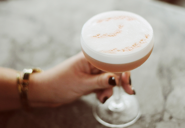 women holding foamy cocktail