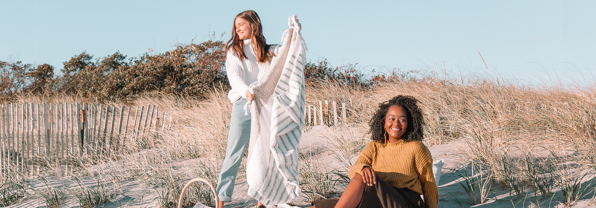 two girls on beach in fall attire
