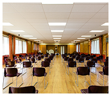 Event space with many rows of brown chairs