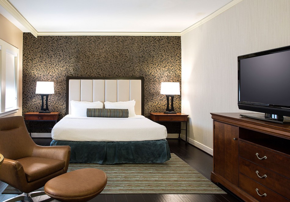 large bed, two night stands, and lounge chair 