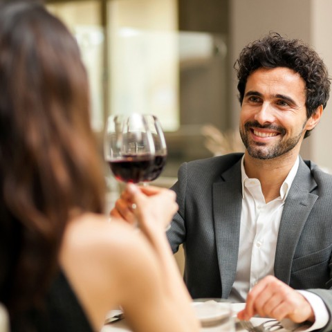 man and woman having a glass of wine  