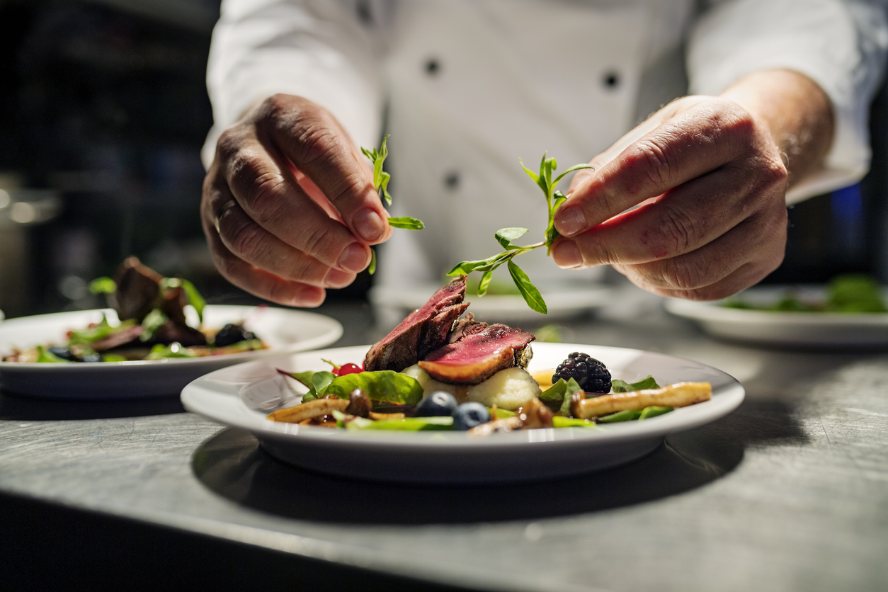 chef placing garnish on dish