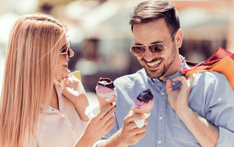 happy young couple shopping eating ice cream and laughing