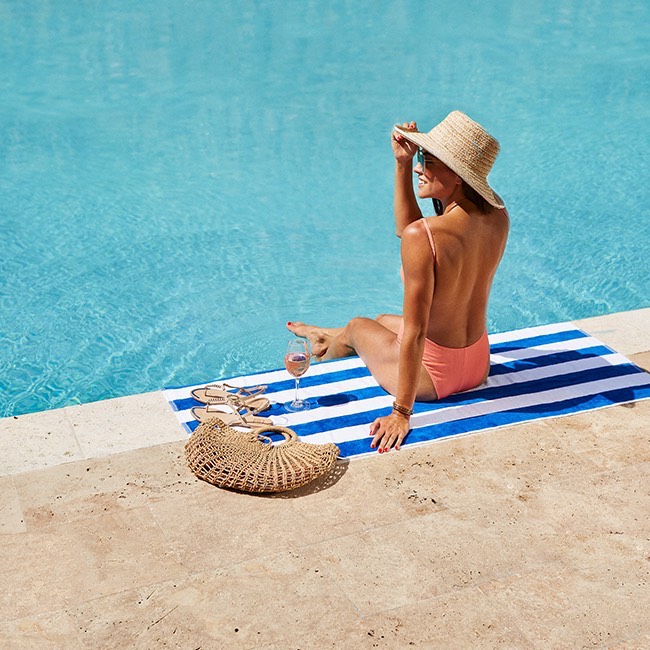 woman sunbathing over the pool