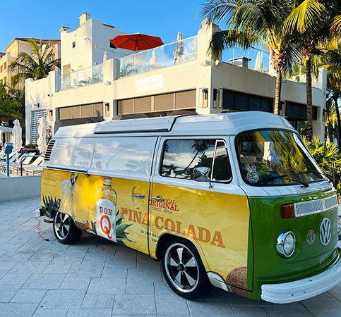 old volkswagen truck with pina colada painting on it