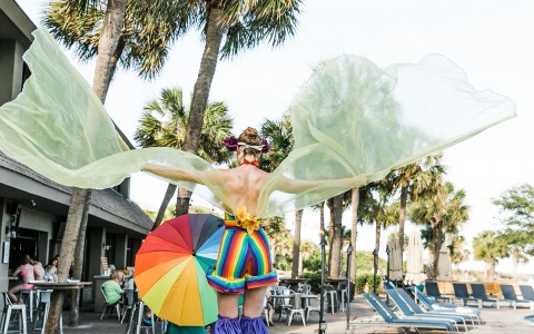 lady in a colorful outfit performing near the pool