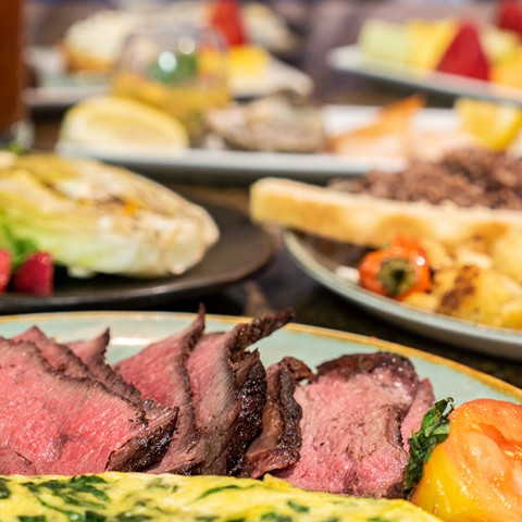 Cut up meat with a side of veggies