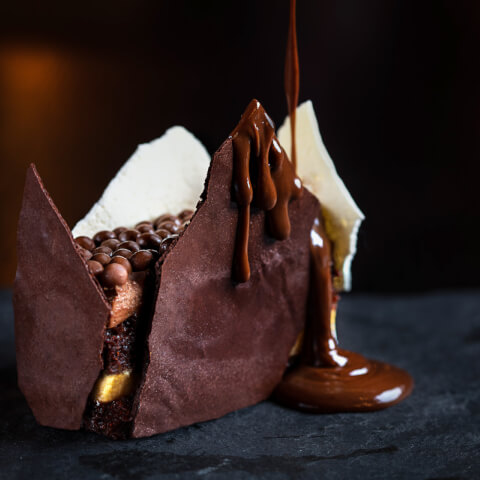 Dripping chocolate on a chocolate dessert 