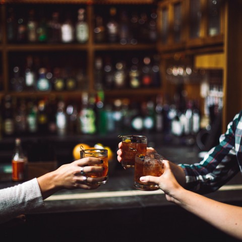 Three friends holding drinks