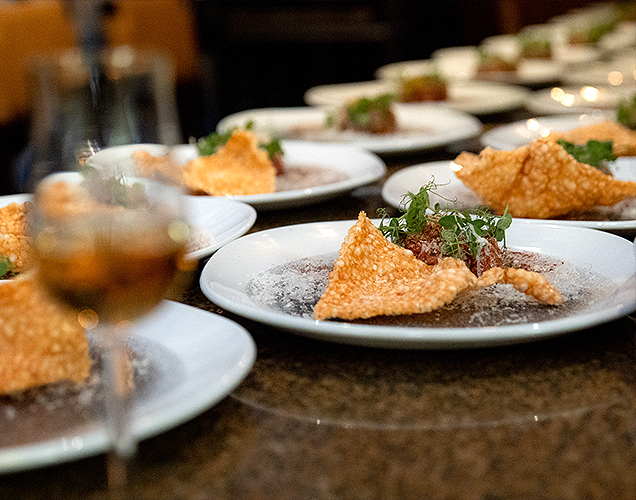 A set up of multiple plates with food for a private dining event