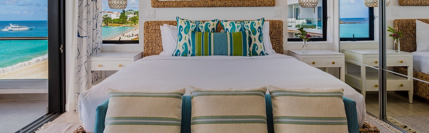 white bed and colorful pillows