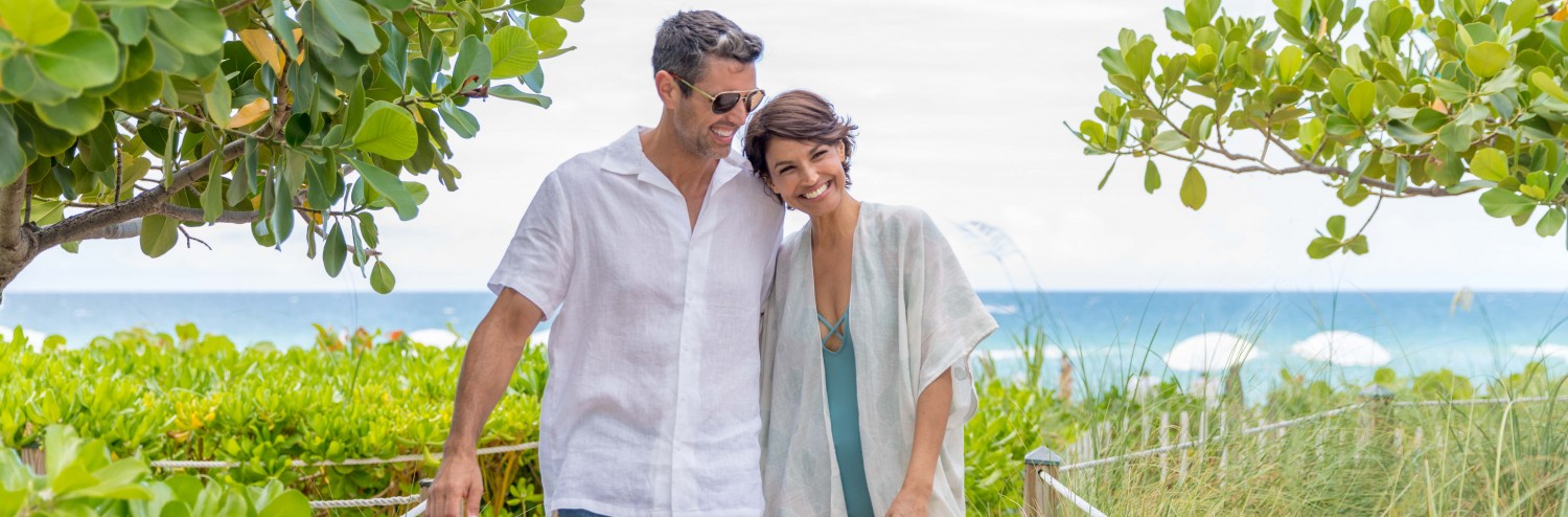 couple walking up a beach ramp