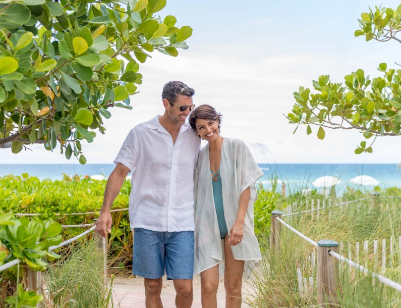couple walking up a beach ramp