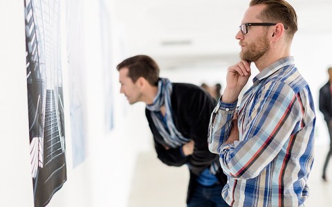men looking at artwork in a gallery