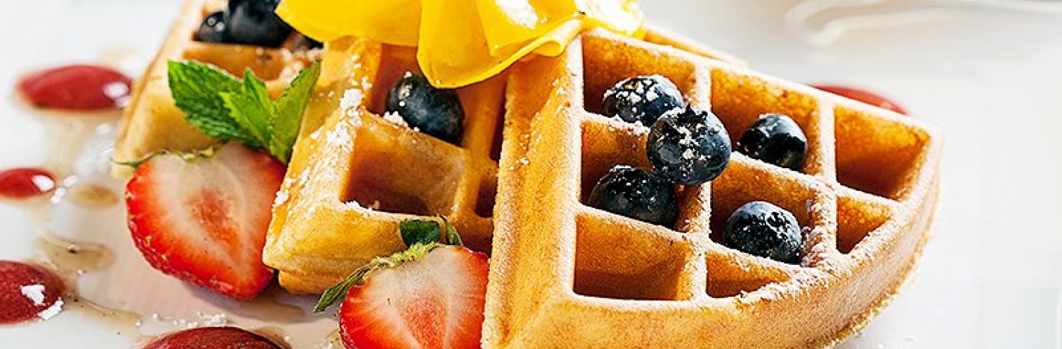 three waffle pieces garnished with fruit