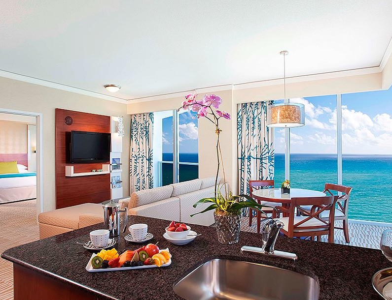 suite with full kitchen and living room suite looking at the ocean