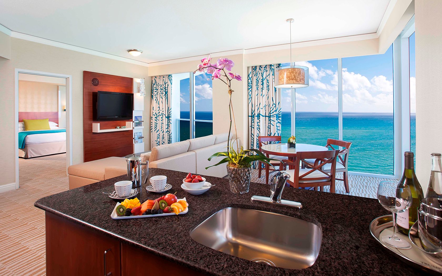 suite with full kitchen and living room suite looking at the ocean