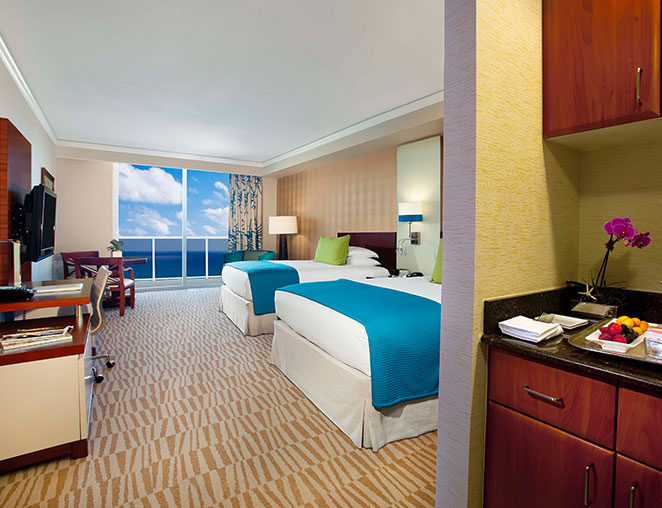 a suite with large windows overlooking the ocean