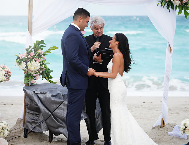 bride and groom saying I do at their beach wedding altar