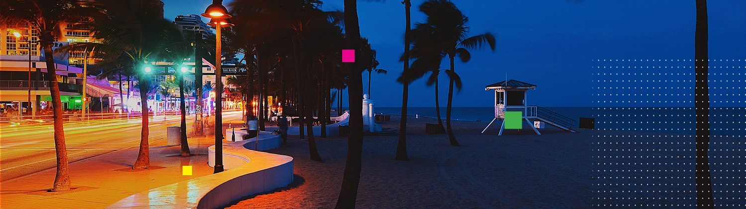 Fort lauderdale beach at night beside lit up road with buildings