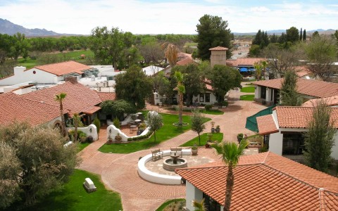 aerial view of the property buildings and a fountain in the middle