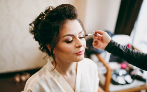 bride getting her makeup applied