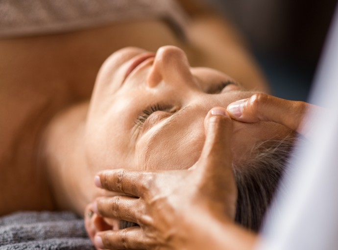 woman receiving a massage on her forehead