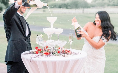 couple pouring champaign on their wedding day