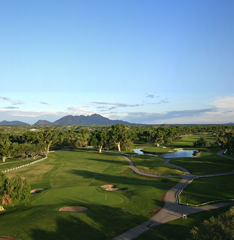 aerial view of golf course with mountains in the distance 