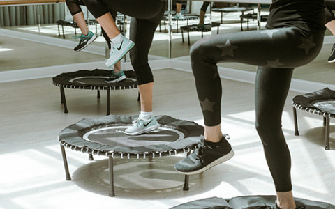 Close up of women stepping onto mini trampolines