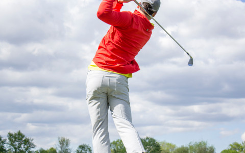 man at final moment of golf swing