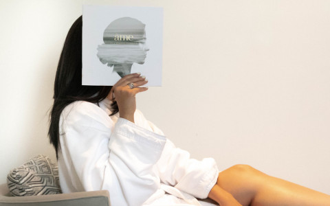 woman holding up spa brochure
