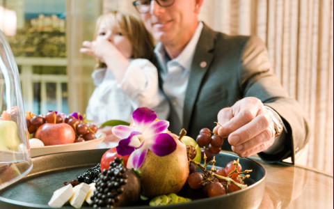 Dad and daughter eating grapes