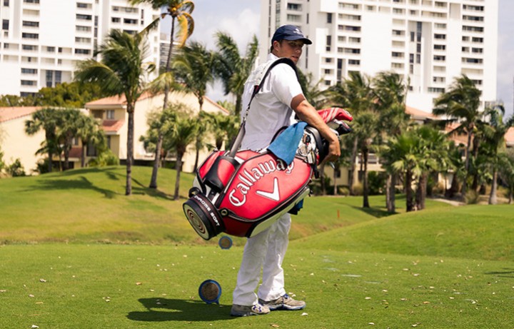 Man carrying golf bag at Turnberry