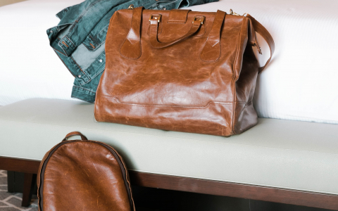 Luggage and jacket on the bed