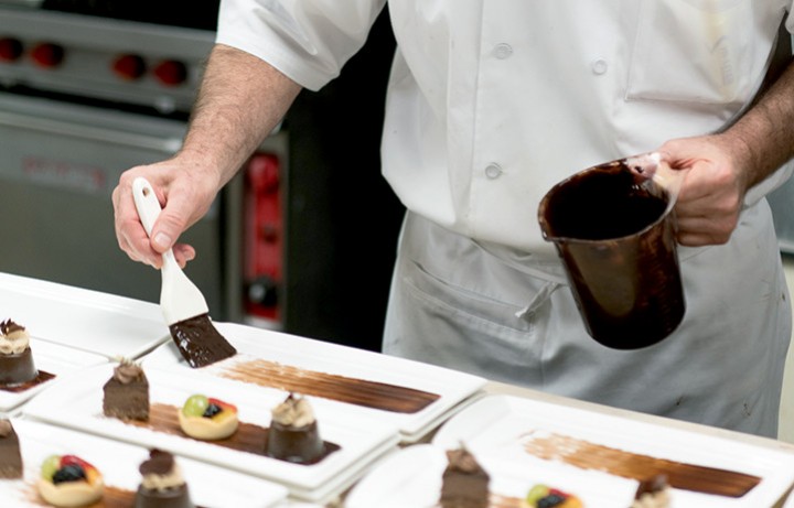 Chef plating dessert at Bourbon Steak