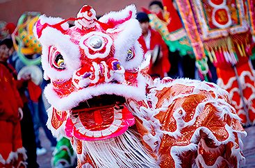Person dressed in an elaborate dragon costume to celebrate Chinese Lunar Year
