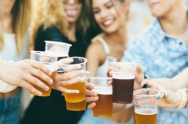 Group of women doing a cheers with beer cups