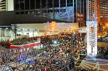 Peachtree Center with a crowd of people outside at night