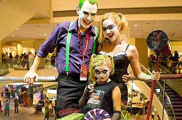 A man, woman, and child dressed in costume at Dragon Con event