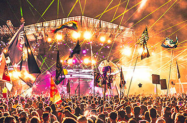 Crowd of people at a concert for Imagine Festival with colorful lights everywhere