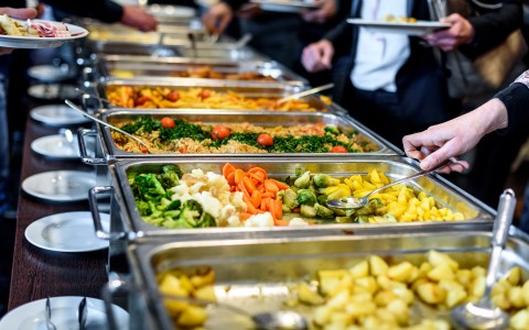 Close up of buffet trays filled with food 